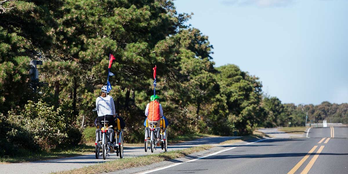 Two bikers on a bike path.