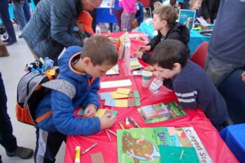 Group of kids working on an art project at a table.