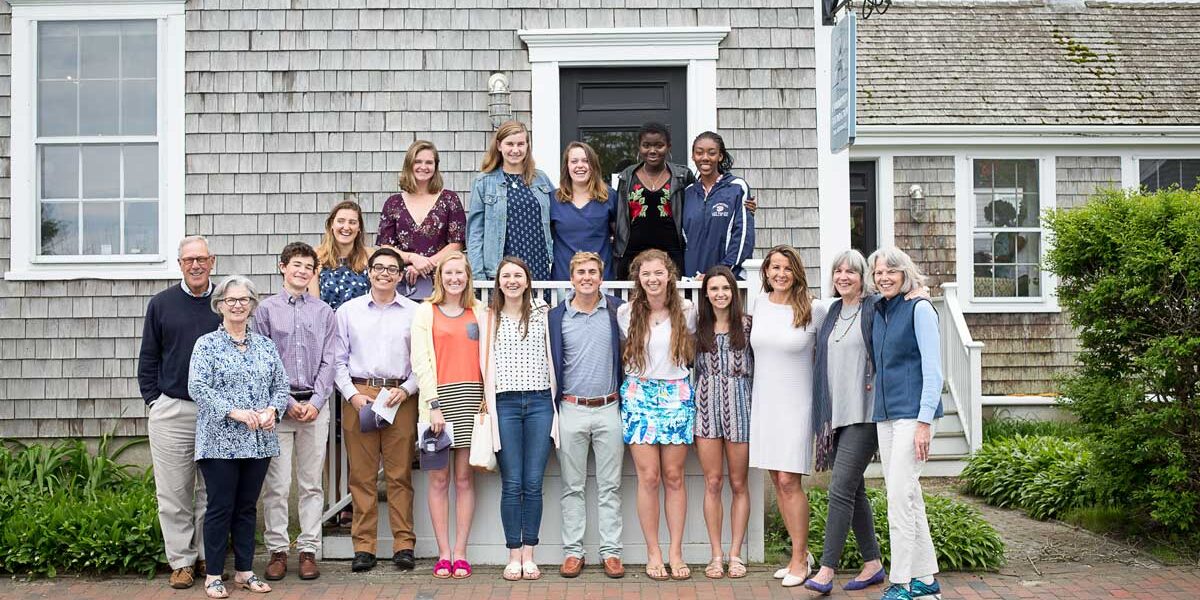 Group of 18 youn scholarship winners on standing on stairs.
