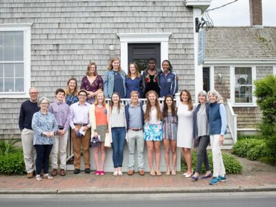 Group of 18 youn scholarship winners on standing on stairs.